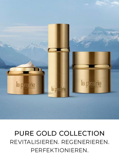 Frascos con tapas doradas de los productos para el cuidado de la piel de la colección Pure Gold de La Prairie presentados sobre un fondo de montañas nevadas. El texto debajo dice: "Colección Pure Gold. Revitalizar. Regenerar. Perfeccionar".