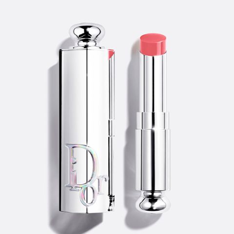 Una botella de base de maquillaje Dior con tapón negro y la inscripción "DIOR" verticalmente en la parte delantera, fotografiada sobre un fondo claro.