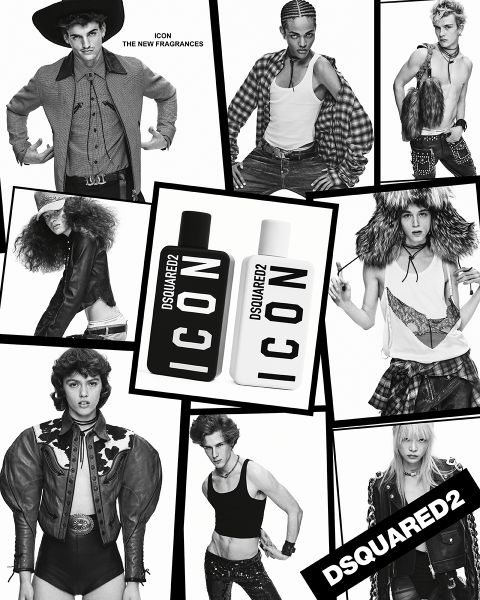 Un hombre con un traje cruzado negro y una corbata gris se encuentra con confianza frente a arte abstracto. A su lado, sobre una superficie de madera, hay una lámpara negra con detalles en latón. El ambiente se ve moderno y elegante.