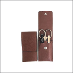 Ein braunes Lederetui, ein geschlossenes und ein offenes. Das offene Etui enthält eine kleine Schere, einen Nagelknipser und ein Metallwerkzeug, die alle sicher in Taschen untergebracht sind. Das Etui hat weiße Nähte und Druckknöpfe zum Verschließen.