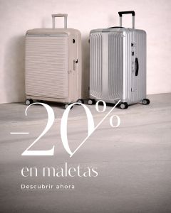 Dos maletas rígidas, una beige y otra plateada, están una al lado de la otra. Texto: "-20% en maletas. Descubrir ahora.
