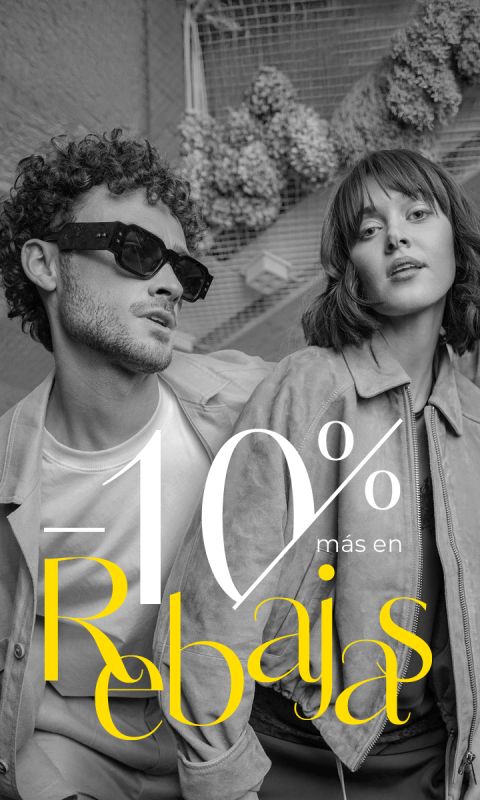 Un hombre y una mujer elegantemente vestidos posan con atuendos de moda; el texto dice «10 % más en Rebajas» en letras grandes blancas y amarillas.