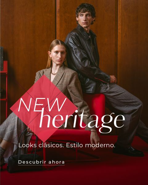 Una mujer y un hombre con ropa elegante sentados en una habitación moderna. El texto dice: "NUEVA herencia. Looks clásicos. Estilo moderno. Descúbrelo ahora".