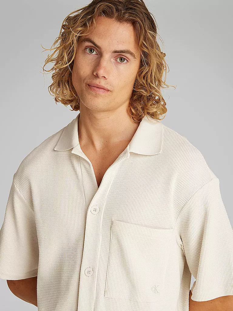 CALVIN KLEIN JEANS | Camisa
Marca: CALVIN KLEIN JEANS
Color: crema
Categorías: Moda, Hombre

Largo de manga: Manga corta
Material: Algodón, Poliéster / Poliamida
Forma del cuello: Cuello Kent
Diseño: Liso
Corte (Prenda superior): Regular
Estilo: Moda joven
Detalles: Bolsi | 